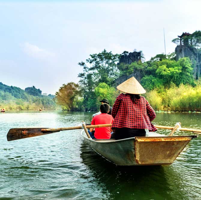 Vietnam hanoi travel by boat in flooded areas submerged trees in yen stream myduc