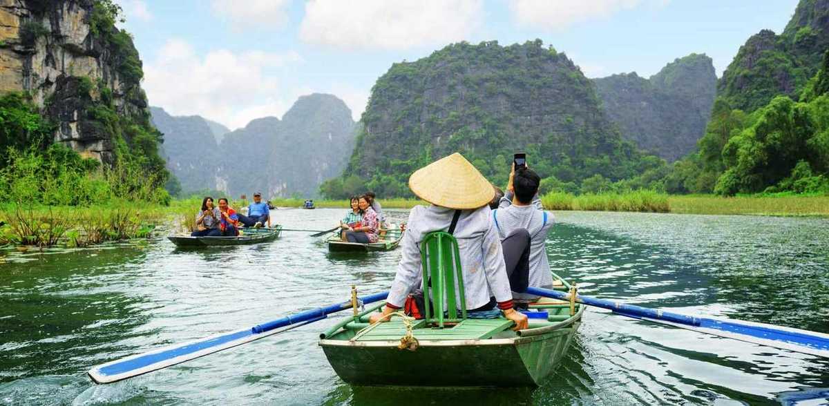 Vietnam ninh binh tourists traveling in boats along the ngo dong river at the tam coc portion