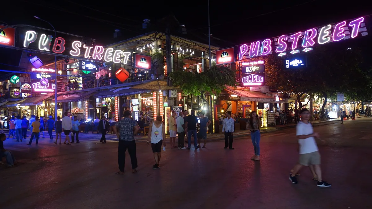 Neon 'Pub Street' signs light up the bustling nightlife strip in Siem Reap, Cambodia.