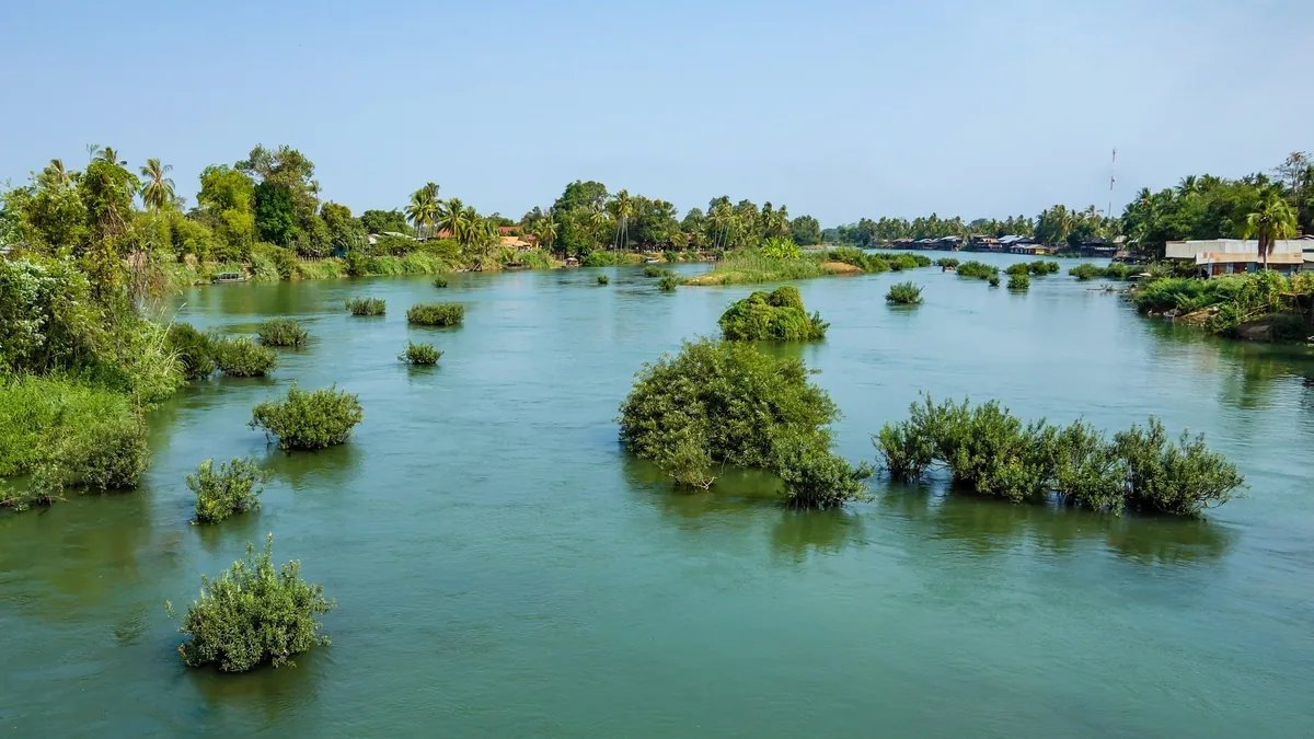 Small green islets dot the wide Mekong River amid the Si Phan Don, or Four Thousand Islands, area of Laos.