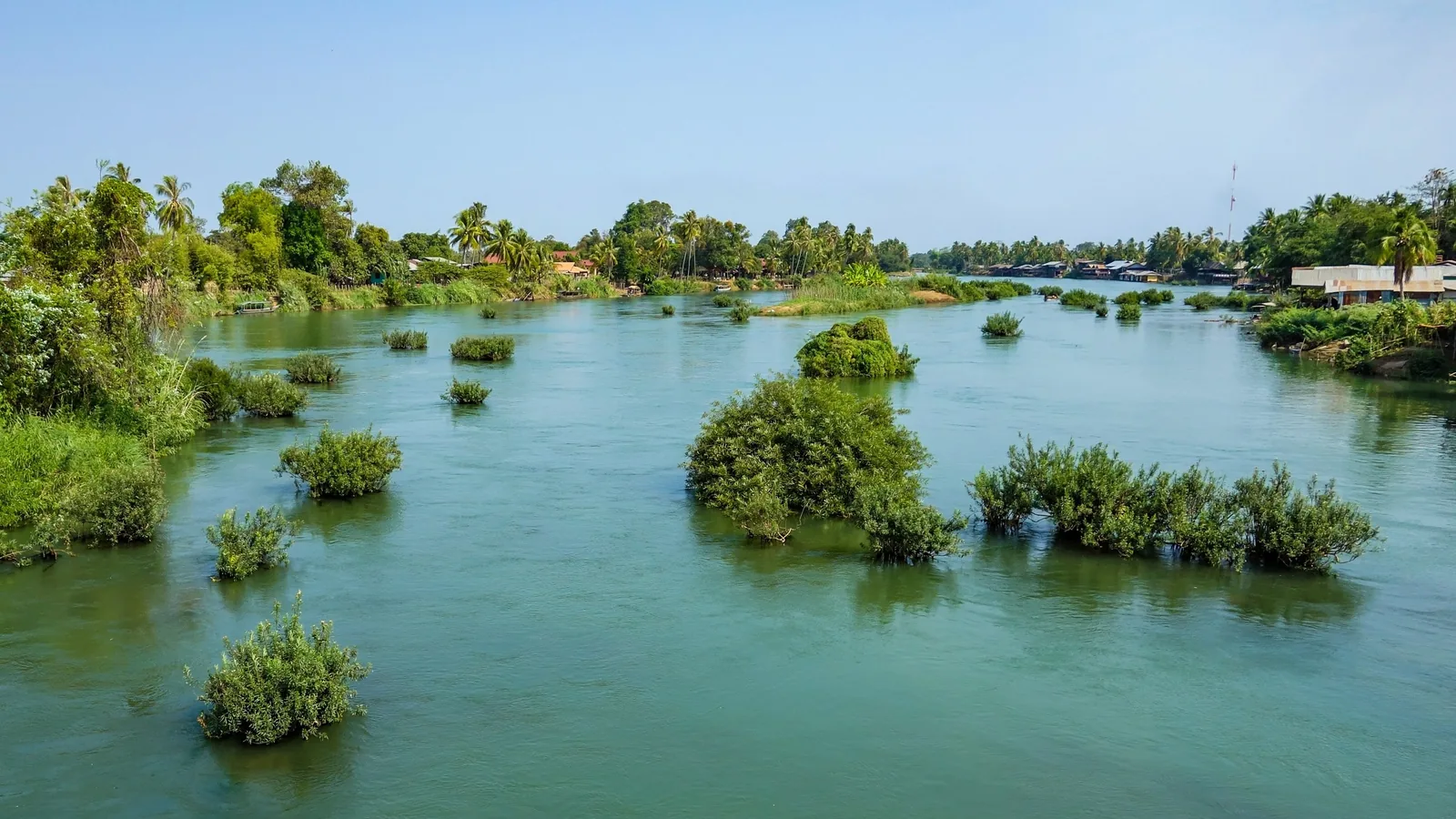 Small green islets dot the wide Mekong River amid the Si Phan Don, or Four Thousand Islands, area of Laos.
