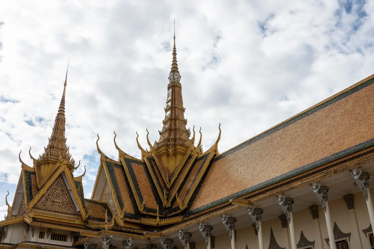Ornate golden spires and tiered roofs crown the Throne Hall at the Royal Palace in Phnom Penh.